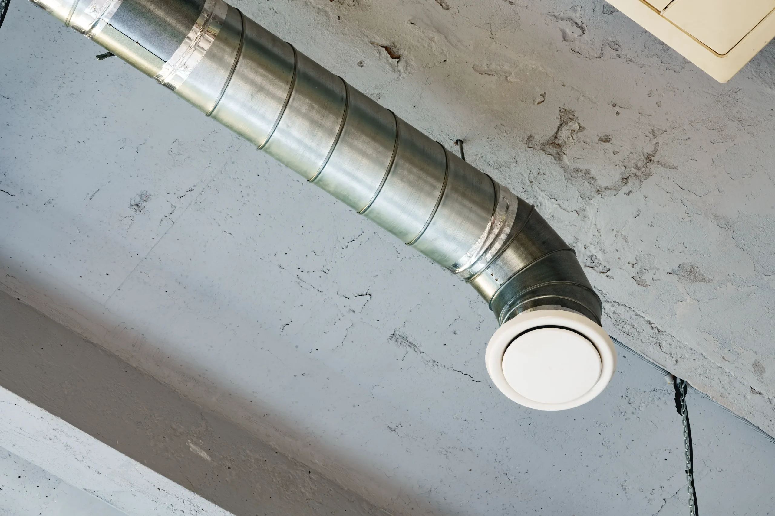 Metal duct and air vent installed on a ceiling